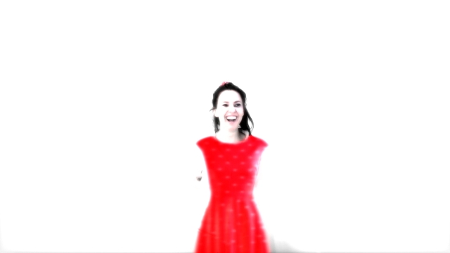 a blurry picture of a young woman in a red dress