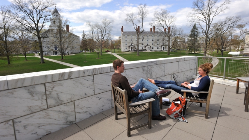 Students relaxing on the patio outside Middlebury's Davis Library.