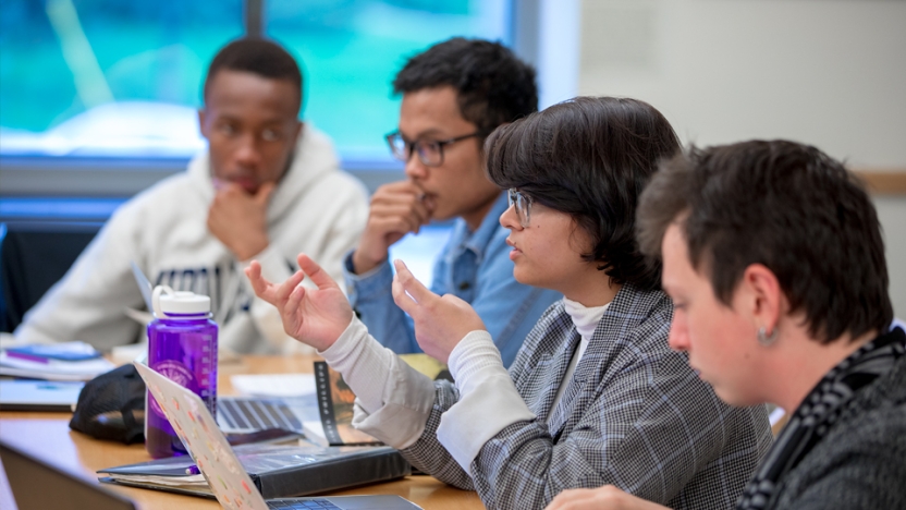 Students discuss a project in class.