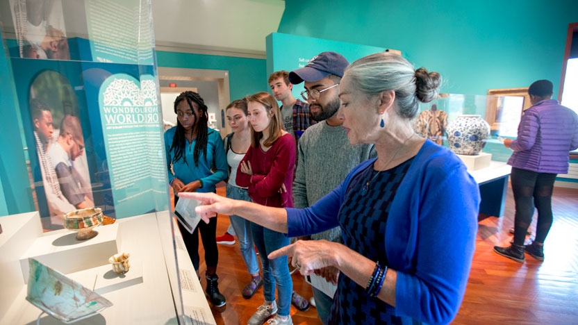 A professor guides students through an exhibit in the college's Museum of Art.