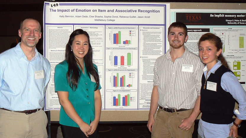 Students and faculty making a poster presentation at a conference.