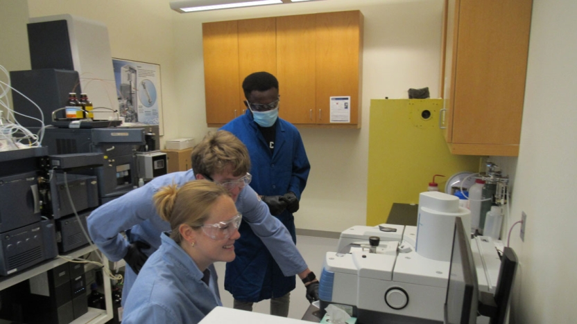 Researchers working in the instrument room learning to use the IR and LCMS (left to right, Lucy Ambach, William Holzman, and Abdul Abubakari)