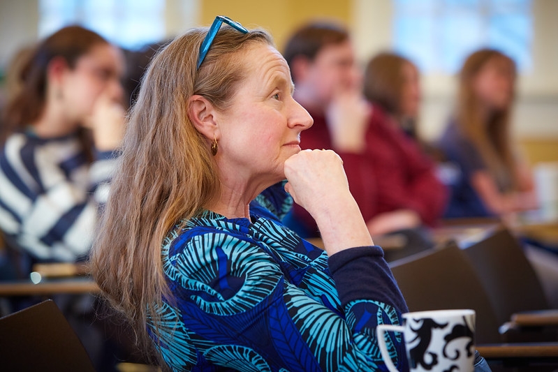Prof. Louisa Burnham listening to Dr. Jeremy Greene, MD, PhD