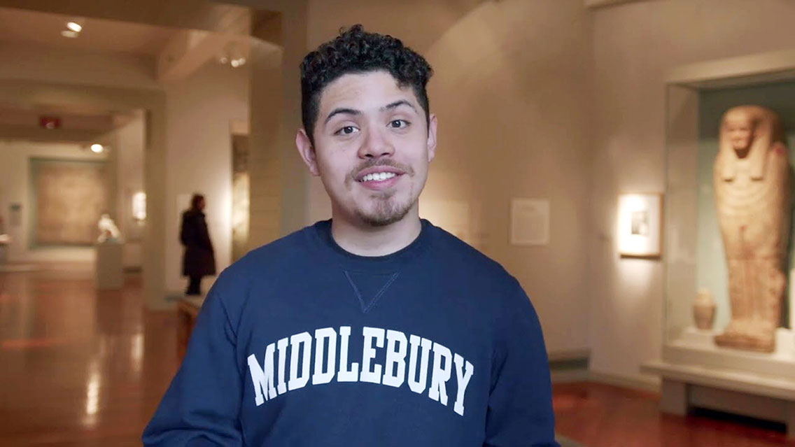 A portrait photo of a smiling man wearing a blue and white Middlebury sweatshirt.