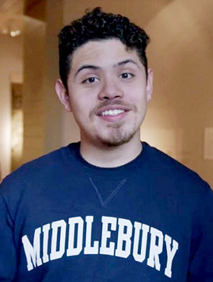 A portrait photo of a smiling man wearing a blue and white Middlebury sweatshirt.