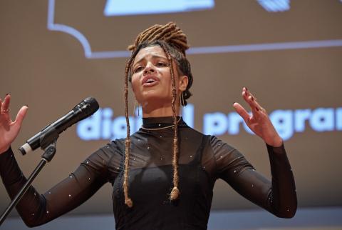 person speaking into a microphone