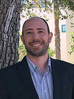 Man with a beard and mustache smiling