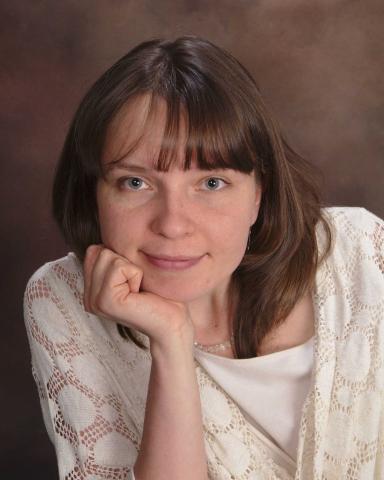 Portrait photo of Tatiana Lukyanova with chin resting in hand