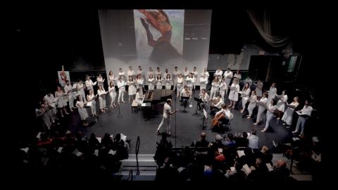 choir dressed in white on a stage