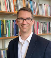 Image of a man wearing a glasses with a white shirt