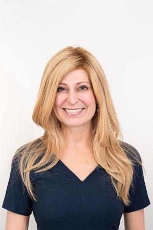 Image of a woman with blonde hair wearing a black shirt