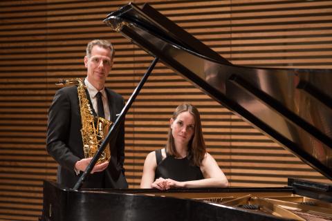 Image of two people holding musical instruments