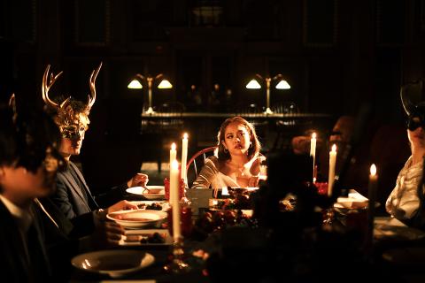 Image of people at a dining table wearing masks