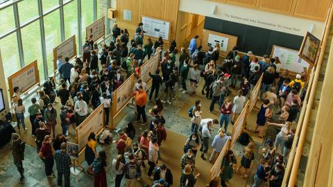Aerial photograph of a large crowd of people gathering for a poster session in Great Hall