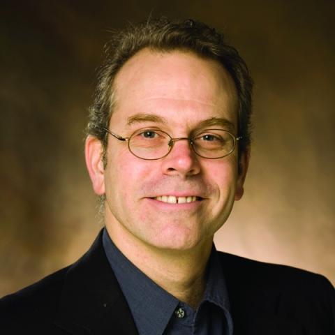 Man wearing glasses and a dark colored shirt