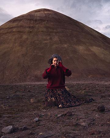 artist kneeling on the ground