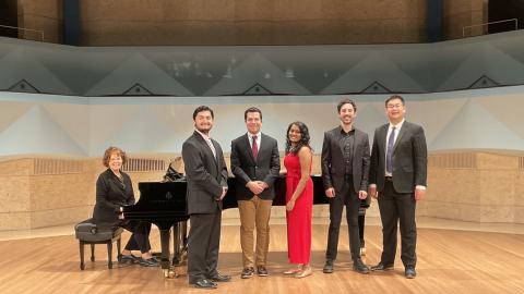 photo of the performers on stage with the accompanist