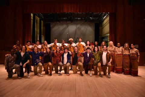 Image of musicians standing on a stage