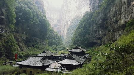A photo of a Chinese hamlet tucked into a narrow valley.