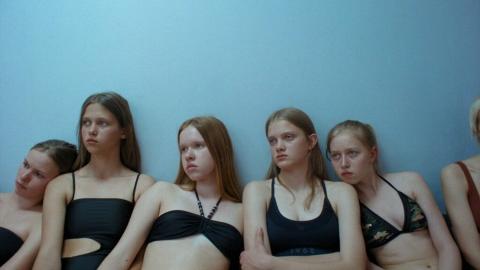 Several young women looking at something off-camera.