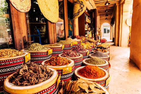 Colorful spread of traditional Arabic dishes with the text 'Celebrate the Flavors of Arabic Cuisine.'