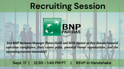 Business people in an office building shaking hands with the skyline in the background.