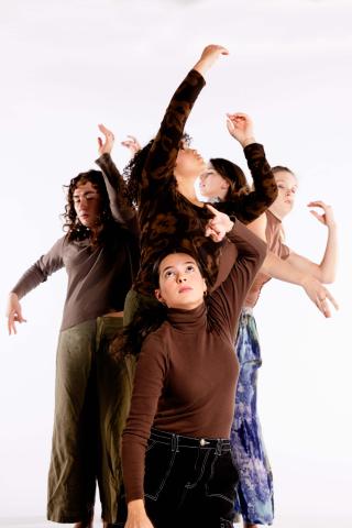 Dancers grouped together, looking up