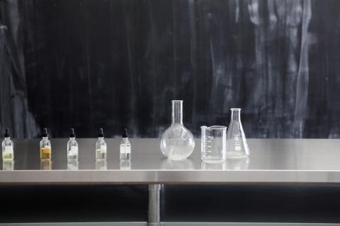 Various aromas displayed in vials on a table.