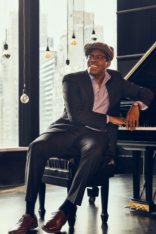 the artist sitting at a piano
