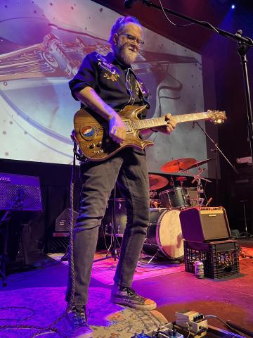 man playing guitar on stage