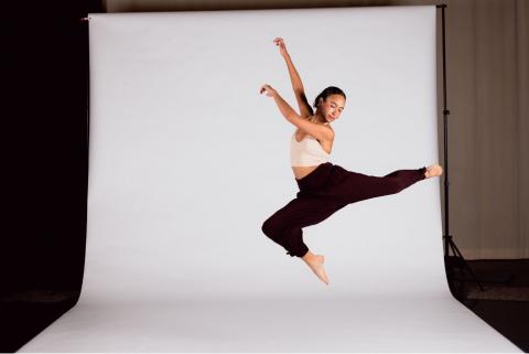 a person dancing in front of a white screen