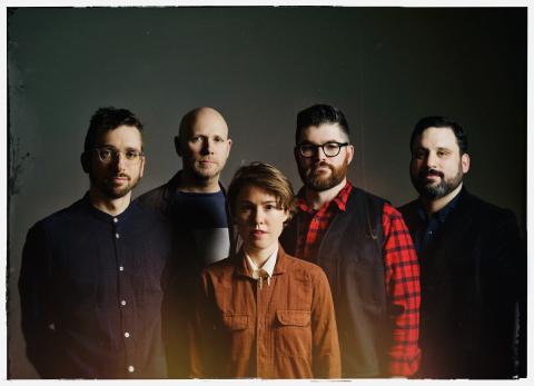 the artists standing together as a group