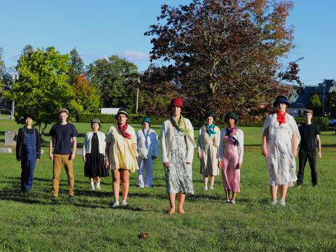 People standing in a group on a lawn