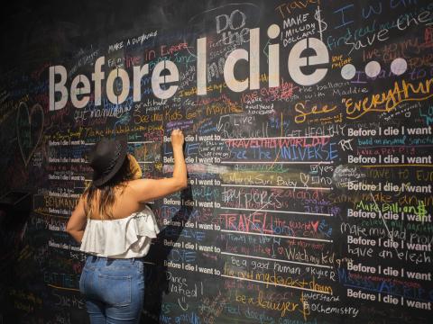 Person writing on a chalk wall