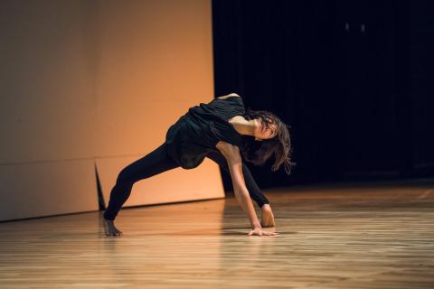 Artist dancing, wearing all black