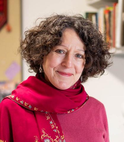 Lady in red shirt smiling.