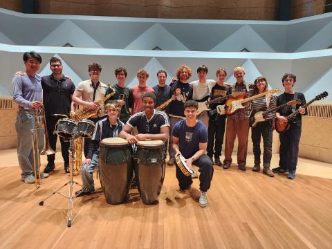 group photo of Afropop students and instruments on Concert Hall stage
