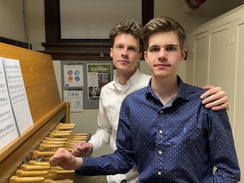 Brothers in blue and white shirts at carillon