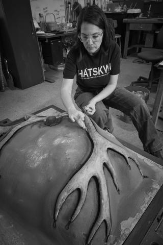 Image of the artist preparing a casting mold of a large elk antler