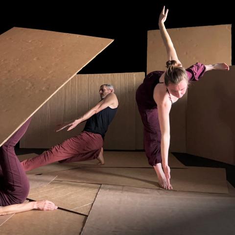 2 dancers dancing with cardboard