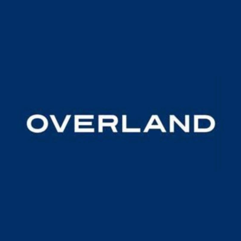 Blue square with white lettering in center, all caps OVERLAND