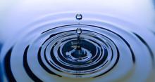 A drop of water causing a ripple effect in a pool