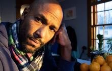 Man with a beard wearing a plaid scarf