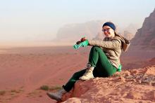 Female student sitting on the edge of a cliff
