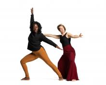 Two dancers against a white background