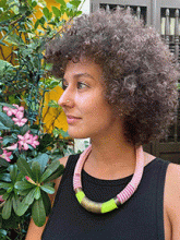 Image of of woman wearing a black blouse and necklace