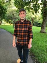 Image of a man wearing a plaid shirt