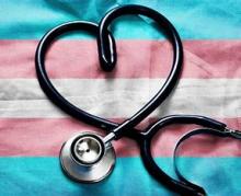 Stethoscope in the shape of a heart on the trans flag