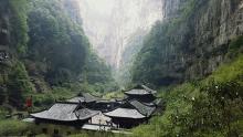 A photo of a Chinese hamlet tucked into a narrow valley.