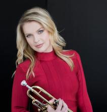 the artist holding her instrument